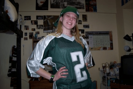 Neidert photo from her time at MSU smiling and wearing a green jersey.