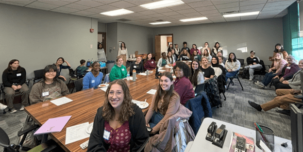 Program participants sit around a table during kickoff event.